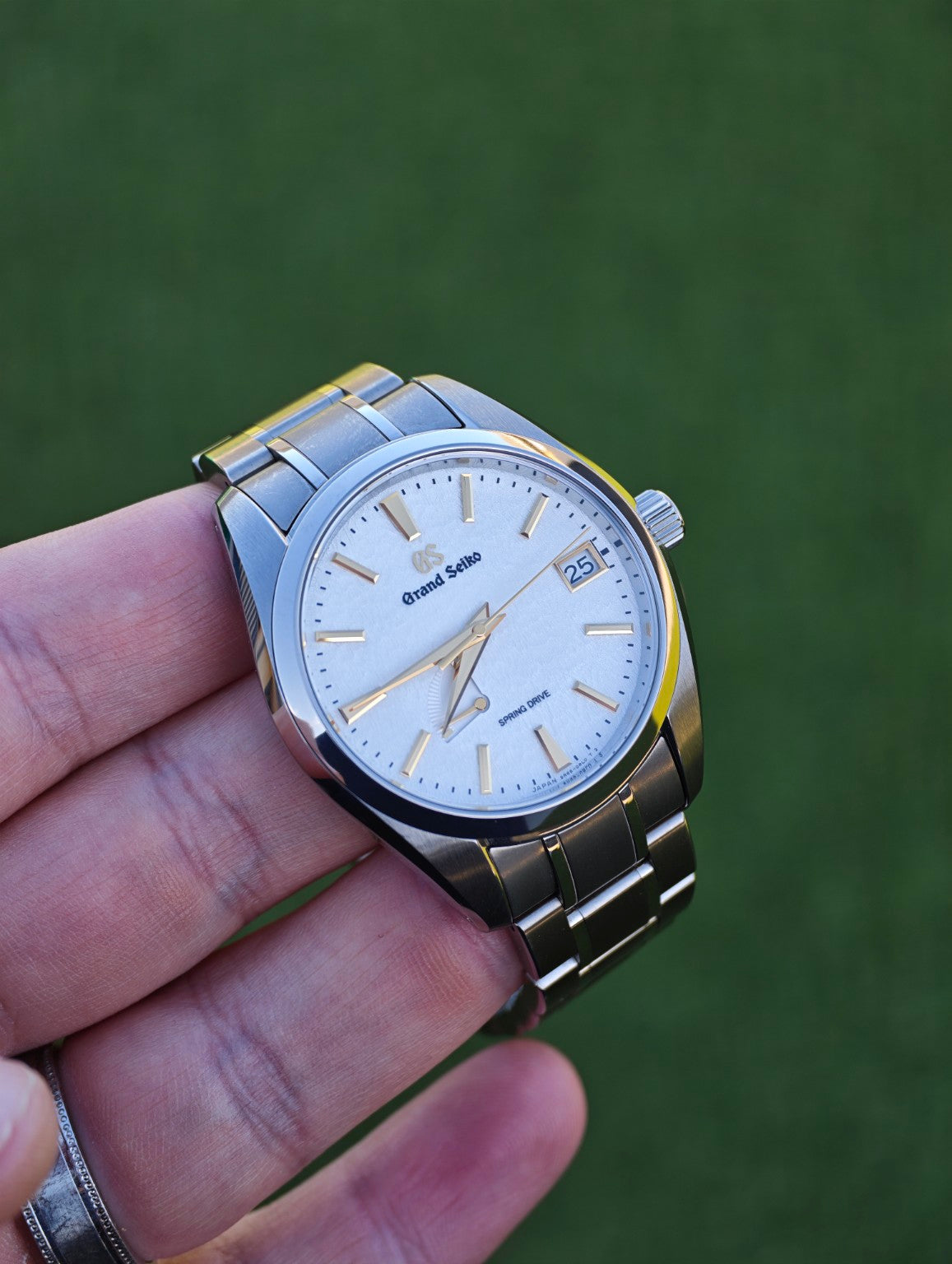 Grand Seiko SBGA259 Golden Snowflake dial and titanium bracelet photographed outdoors
