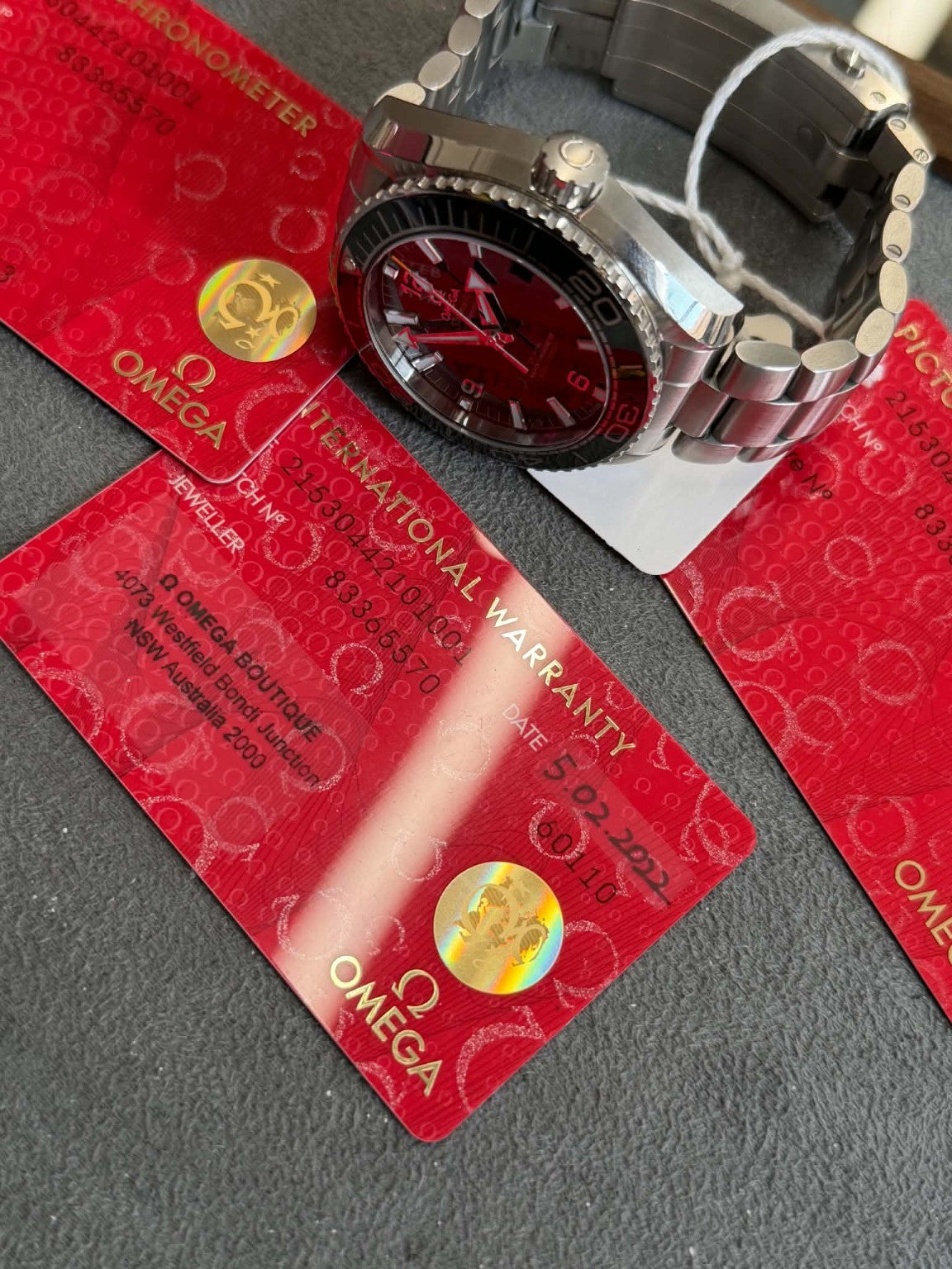 Omega Planet Ocean with its original Omega warranty and accompanying cards