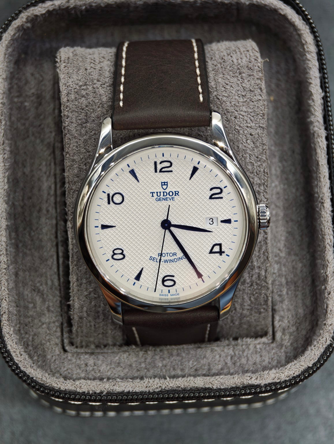 Front view of the Tudor 1926 on its brown leather strap